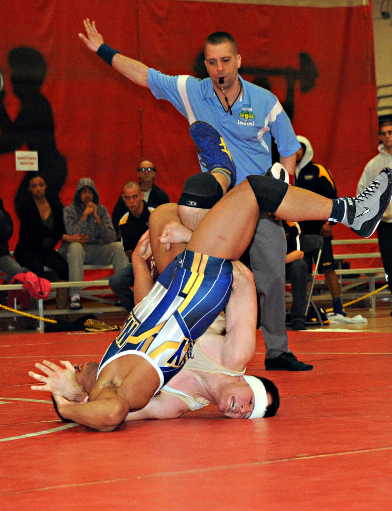 Army William Simpson earns two points when Navy Sheldon Wilder’s back breaks 90 degrees from the mat during the duo’s scramble for position in the 60 kg. freestyle match March 17, 2013, at the Armed Forces Wrestling Championship, in Griffith Field House at Joint Base McGuire-Dix-Lakehurst, N.J. Simpson is assigned to Fort Riley, Kansas. He is a Nashville native. Wilder is assigned to the USS Iwo Jima in Norfolk, Va., and calls Durham, N.C., home. (U.S. Air Force photo by Senior Master Sgt. Denise Johnson/Released)