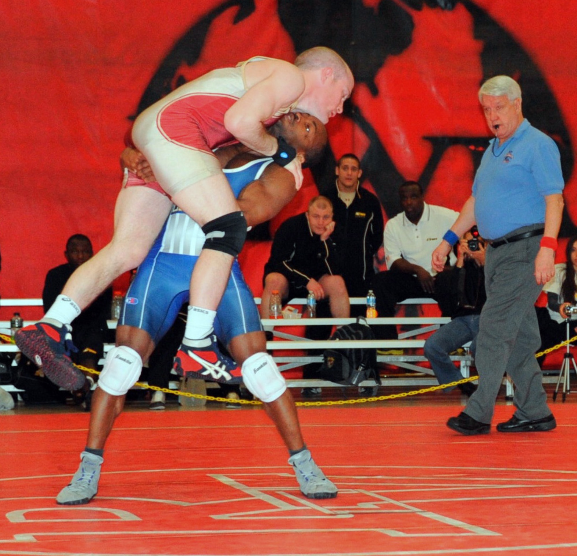 Navy Darnell Jones executes a single leg lift on Army Nate Engel in the 55 kg. freestyle match March 17, 2013, at the Armed Forces Wrestling Championship, in Griffith Field House at Joint Base McGuire-Dix-Lakehurst, N.J. The lift fails and Engel comes back with a pin for the win shortly after. Jones is assigned to Assault Craft Unit 4 in Little Creek, Va. He is a native of Norcross, Ga. Engel, stationed at Fort Carson, Colo., hails from St. Helena, Calif. (U.S. Air Force photo by Senior Master Sgt. Denise Johnson/Released)