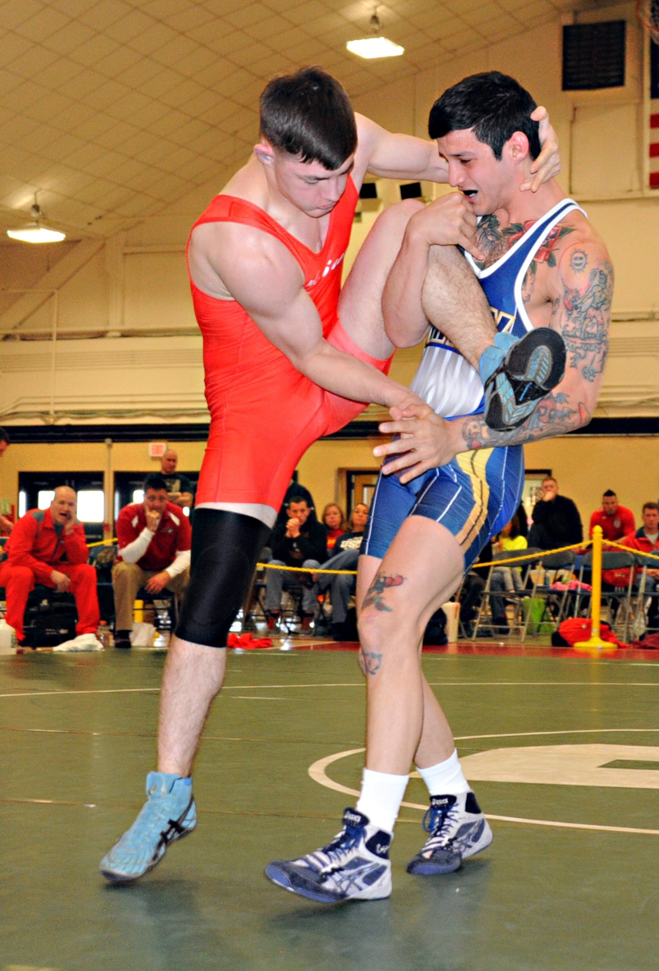 Navy Dietrich Zacher attempts a take down by applying a single-leg lift on Marine Alexander Holloway March 17, 2013, at the Armed Forces Wrestling Championship, in Griffith Field House at Joint Base McGuire-Dix-Lakehurst, N.J., in the 66 kg. weight class. This second day of the Armed Forces Wrestling Championship put the athletes’ freestyle skills to the test, which enables leg grabbing and moves below the waist, unlike day one’s Greco-Roman matches. Zacher is assigned to the South West Regional Maintenance Center in San Diego. He calls San Diego home. Holloway, a Marietta, Ga., native, is assigned to Headquarters Support Battalion at Camp Lejeune, N.C. (U.S. Air Force photo by Senior Master Sgt. Denise Johnson/Released)