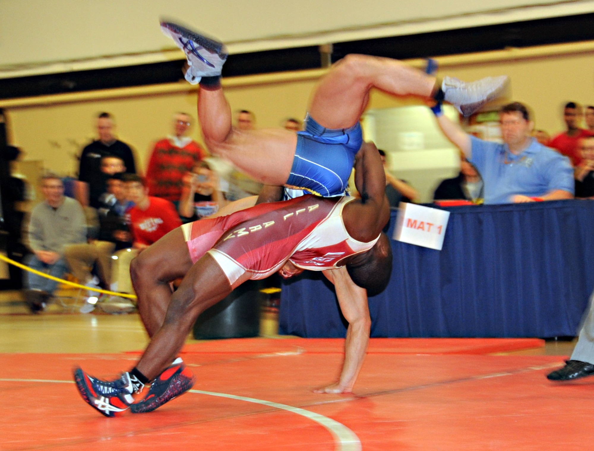 Army Spenser Mango straightlifts Navy Sheldon Wilder from the par tier position for 5 points in the Greco-Roman 60 kg. class March 16, 2013, in Griffith Field House at the Armed Forces Wrestling Championship, at Joint Base McGuire-Dix-Lakehurst, N.J. Mango is stationed at Fort Carson, Colo. He hails from St. Louis, Mo. Wilder is assigned to the USS Iwo Jima in Norfolk, Va., and calls Durham, N.C., home. (U.S. Air Force photo by Senior Master Sgt. Denise Johnson/Released) 