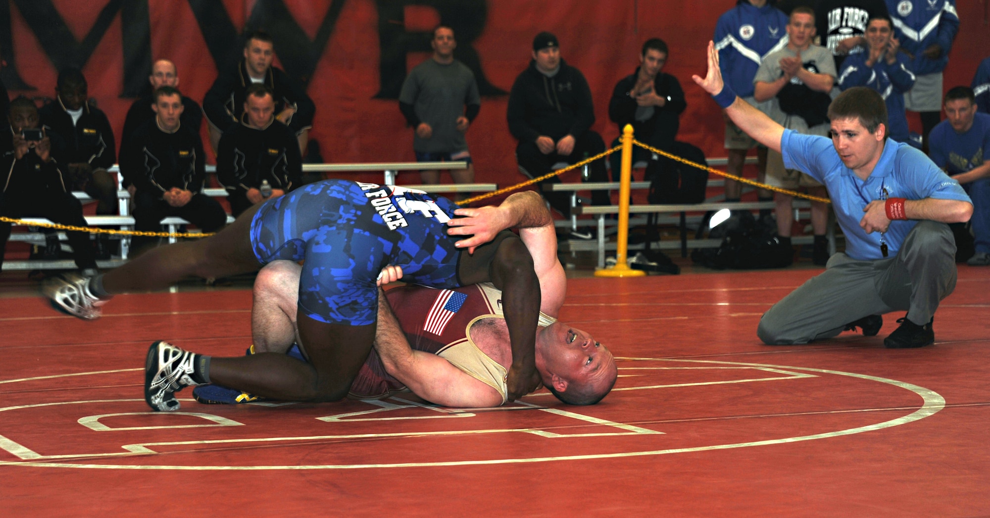 Air Force Terrell Walker tries for a pin to counter Army Oscar Wood’s attempt at a throw in the 84 kg. Greco Roman style match March 16, 2013, at the Armed Forces Wrestling Championship, at Joint Base McGuire-Dix-Lakehurst, N.J. Wood, a 2004 Olympic wrestling team and Army assistant coach, holds his opponent off with leverage on Walker’s hip. Walker scrambles to get chest-to-chest, the most dominant wrestling position which provides a controlled center of gravity and diminishes an opponent’s ability to escape. This was Walker’s first duel in an Armed Forces championship. Walker won the first period, 5-0, bringing his team to their feet. Wood came back to win the two subsequent periods and thus the round, though Wood suffered a displaced rib in the duel. Walker is stationed at Joint Base Langley-Eustis, Va., and calls Eglin, Ill., home. Wood is stationed at Fort Carson, Colo. He hails from Gresham, Ore. (U.S. Air Force photo by Senior Master Sgt. Denise Johnson/Released)