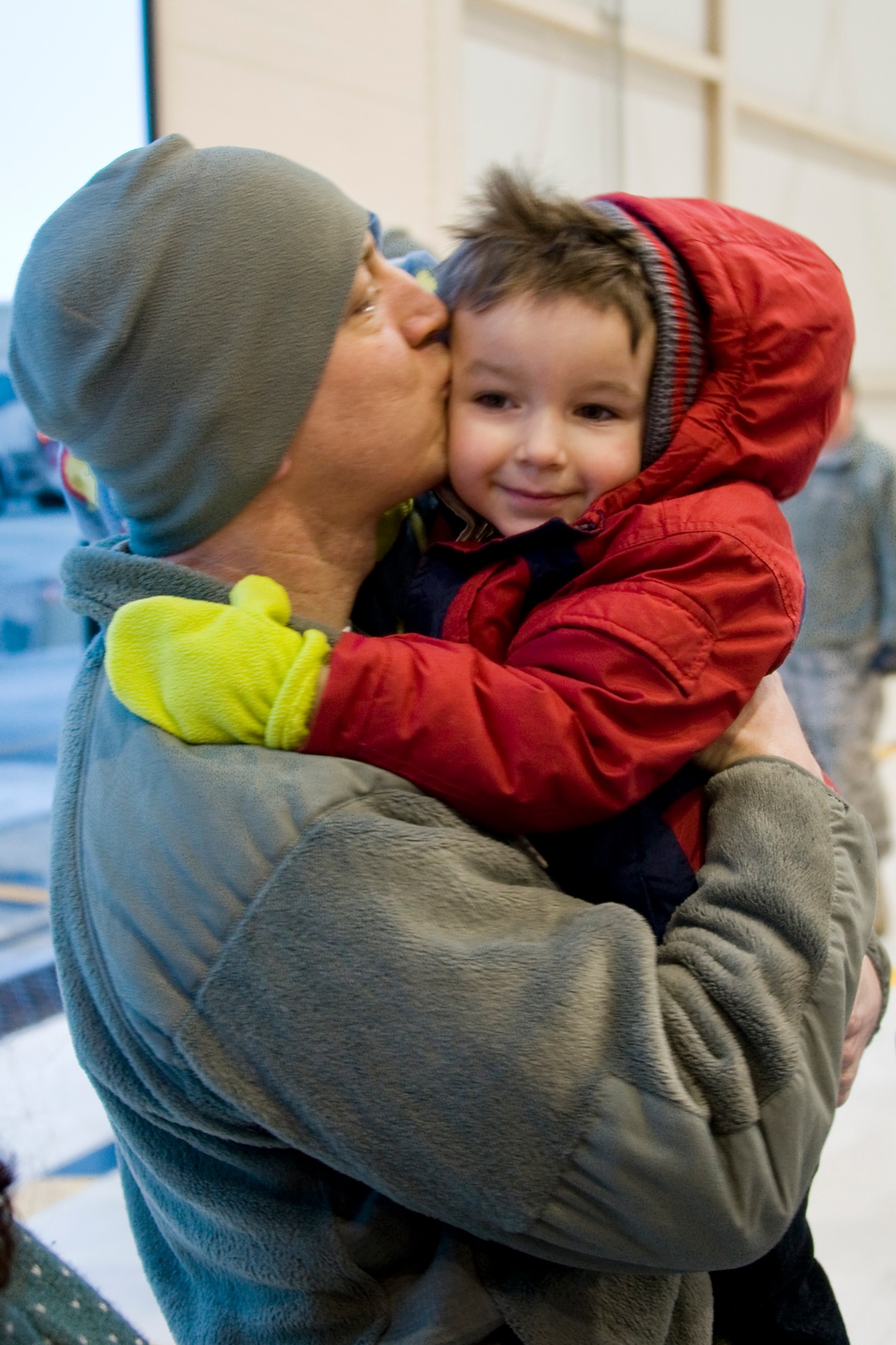 GRISSOM AIR RESERVE BASE, Ind. -- Tech. Sgt. Jarred Gentile, 434th Security Forces Squadron fire team member, gives his son, Noah, a kiss after returning from a deployment to the Transit Center at Manas, Kyrgyzstan, March 6. Families and friends of the deployers filled Dock 6 to welcome back their loved ones. (U.S. Air Force photo/Senior Master Sgt. Scott Fleek)
