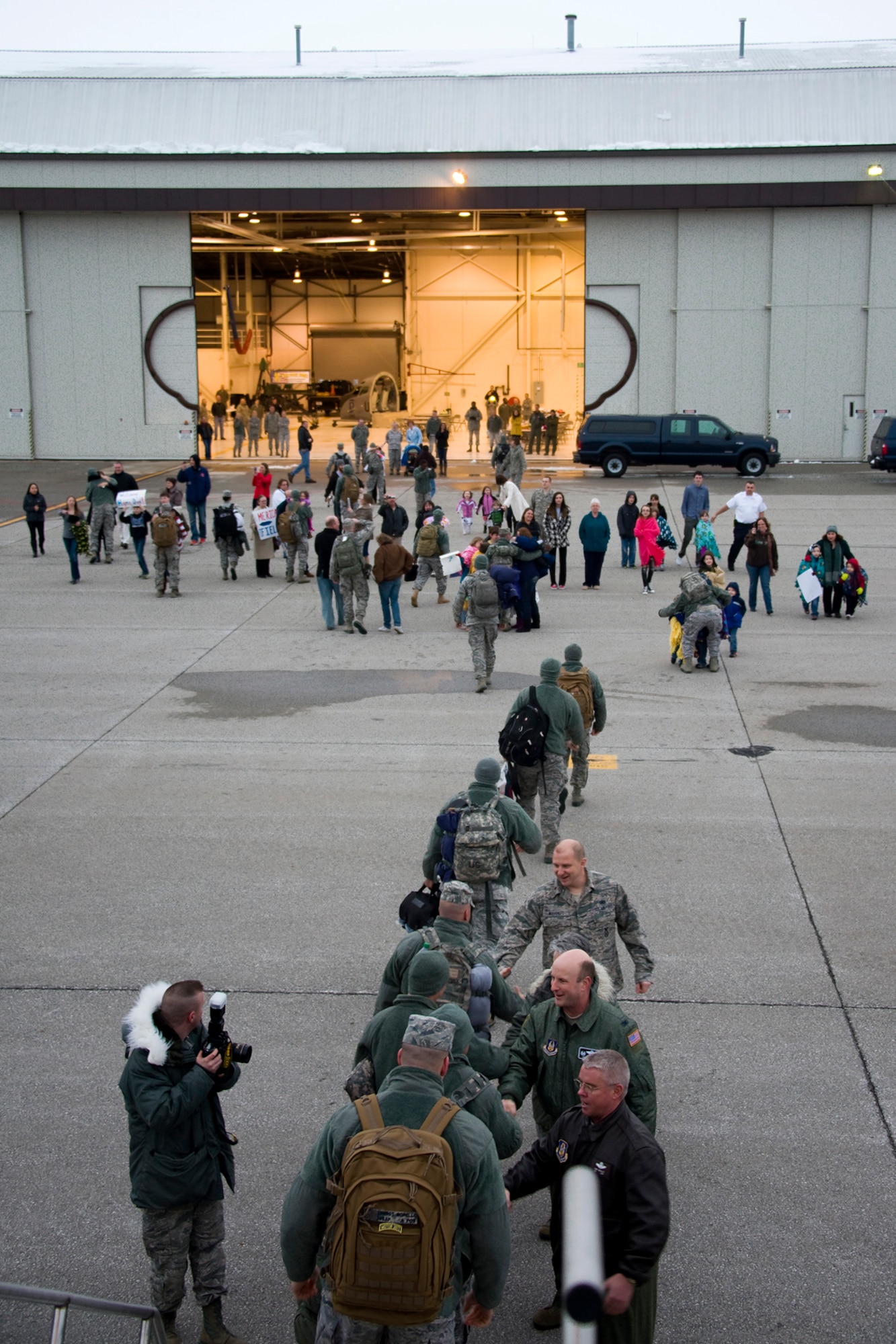 GRISSOM AIR RESERVE BASE, Ind. -- More that 20 434th Security Forces Squadron Airmen rush to meet their families and friends after returning to Grissom from a six-month deployment to the Transit Center at Manas, Kyrgyzstan, March 6. Also welcoming back the deployers were Col. Don Buckley, 434th Air Refueling Wing commander; Col. Christopher Amend, 434th Operations Group commander; Lt. Col. Maureen McAllen, 434th Mission Support Group commander; and Maj. James Benvenuto, 434th SFS operations officer. (U.S. Air Force photo/Senior Master Sgt. Scott Fleek)
