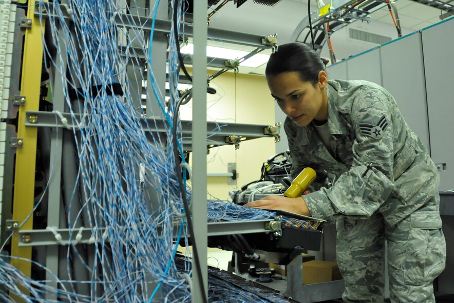 Senior Airman Sharon Navarro, 482nd Communications Squadron Knowledge Operations Manager, wires telecommunications cable in the Telephone Central Office at Homestead Air Reserve Base, Fla., Mar. 14. The Telephone Central Office hosts all of Homestead ARB’s phone lines, alarm circuits, commercial communications lines, and television services. (U.S. Air Force photo/Nicholas Caceres)