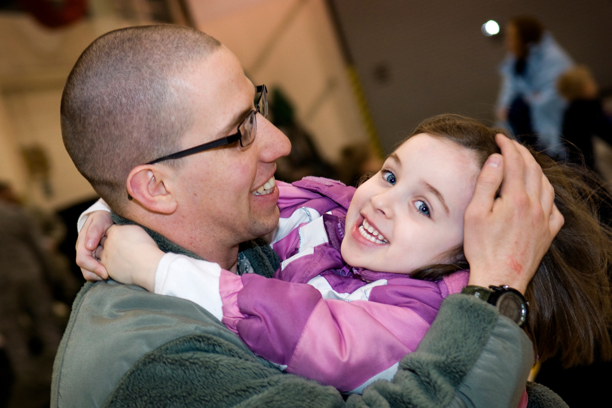 GRISSOM AIR RESERVE BASE, Ind. -- Staff Sgt. Michael McClintock, 434th Security Forces Squadron fire team member, shares a special moment with his daughter, Bailey, after not seeing her for more than six months March 6. McClintock and 20 other 434th SFS Airmen deployed to the Transit Center at Manas, Kyrgyzstan, to provide security for the base. (U.S. Air Force photo/Tech. Sgt. Mark R. W. Orders-Woempner)
