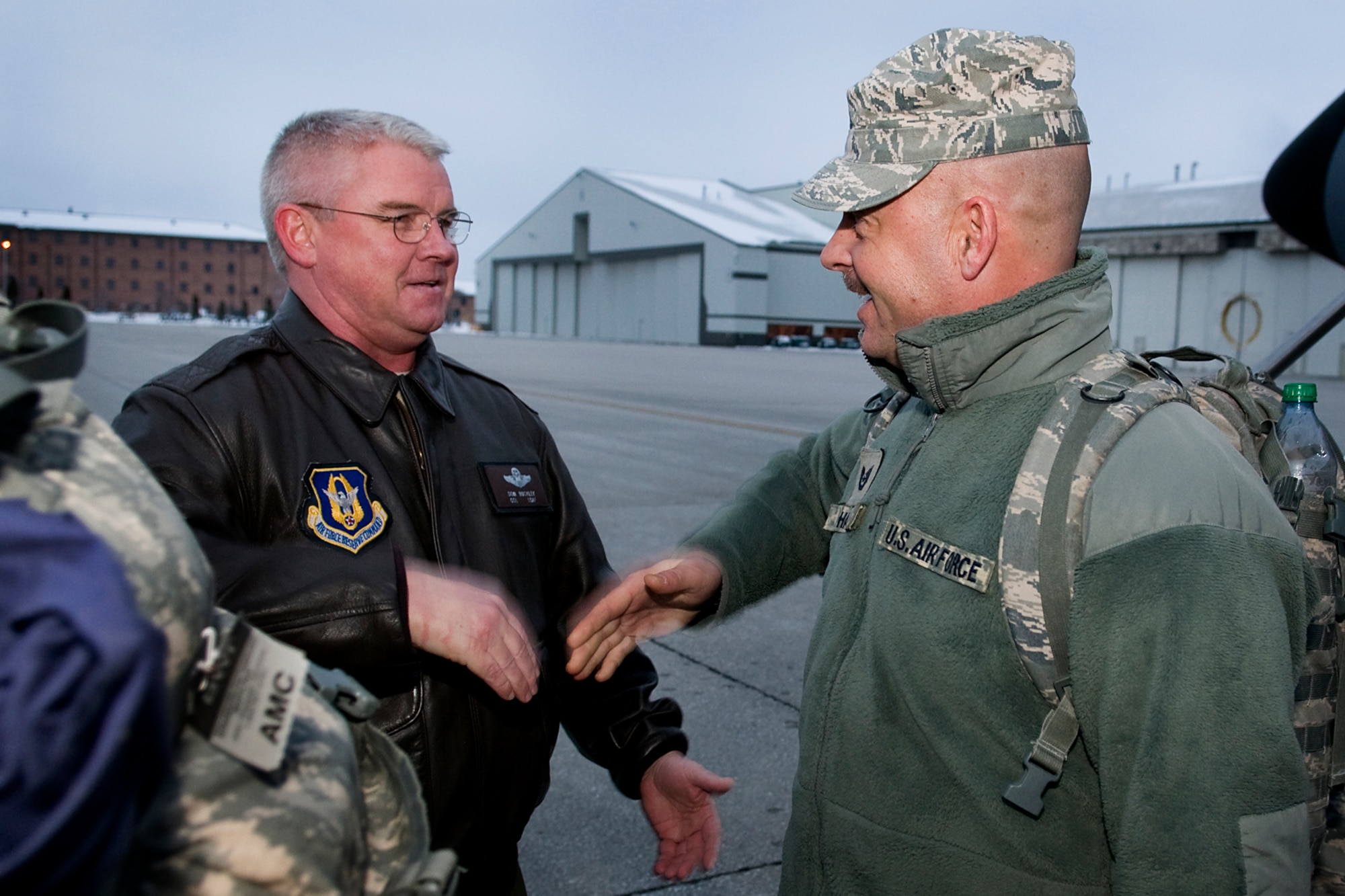 GRISSOM AIR RESERVE BASE, Ind. -- Col. Don Buckley, 434th Air Refueling Wing commander, welcomes back Tech. Sgt. Brian Haase, 434th Security Forces Squadron fire team member, as he returns to Grissom after a six-month deployment to the Transit Center at Manas, Kyrgyzstan, March 6. More than 20 434th SFS troops deployed to the base to support its security. (U.S. Air Force photo/Tech. Sgt. Mark R. W. Orders-Woempner)
