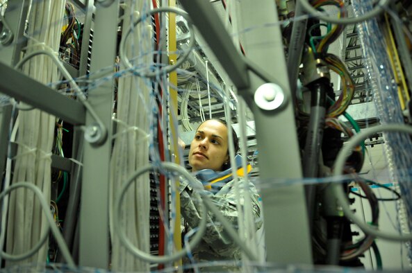 Senior Airman Sharon Navarro, 482nd Communications Squadron Knowledge Operations Manager, checks for dial tone after connecting a new phone line in the Telephone Central Office at Homestead Air Reserve Base, Fla., Mar. 14. The Telephone Central Office hosts all of Homestead ARB's phone lines, alarm circuits, commercial communications lines, and television services. (U.S. Air Force photo/Senior Airman Nicholas Caceres) 

