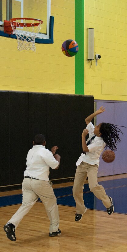 Team Andrews children shoot baskets during an obstacle course competition at the Joint Base Andrews Youth Center on March 19, 2013.  The youth center hosted an open house to celebrate the completion of renovations to the gym. (U.S. Air Force photo/Staff Sgt. Torey Griffith)