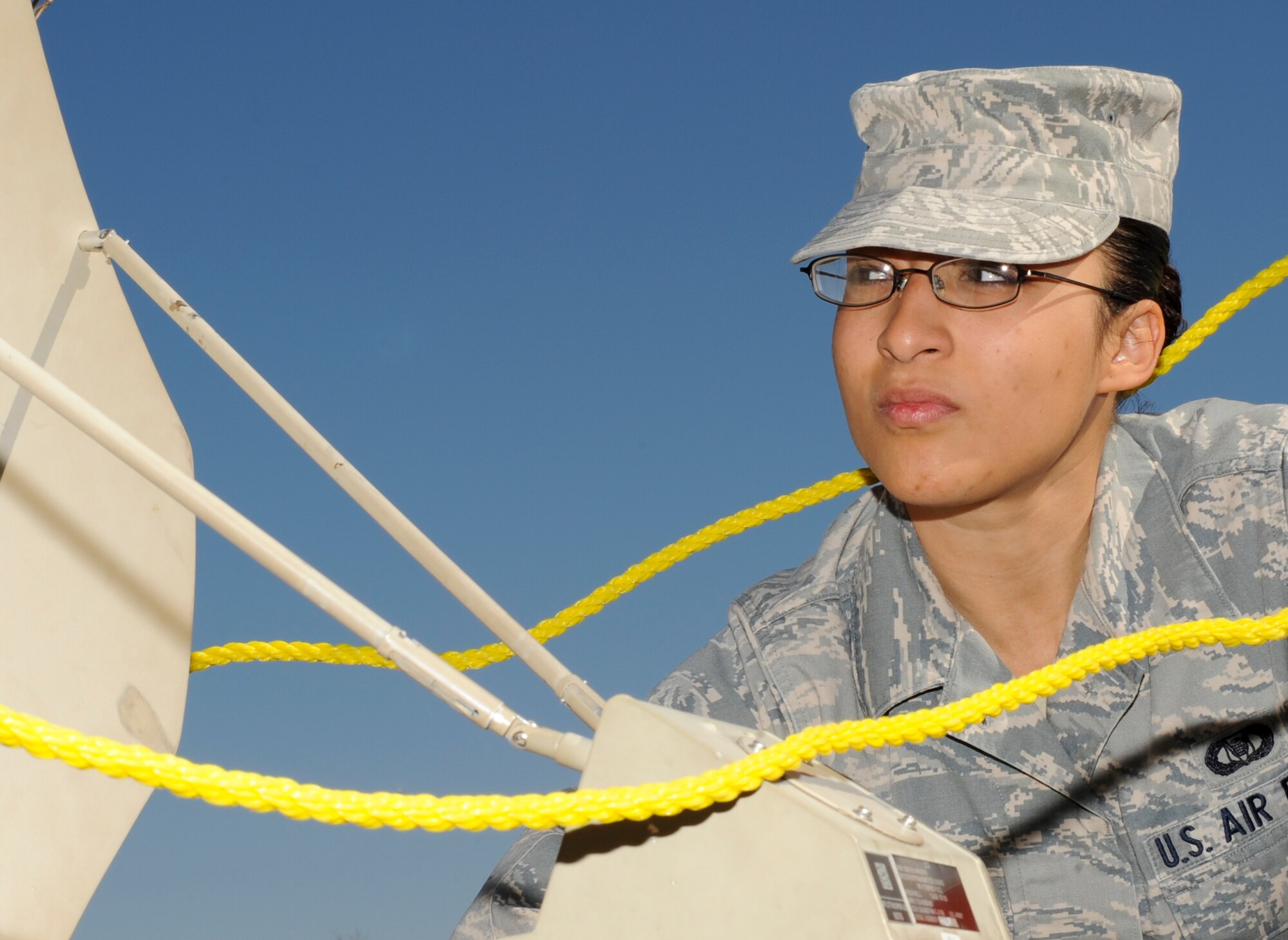 Staff Sgt. Victoria Carrero, 22nd Air Refueling Wing command post senior controller, checks the GPS on the single channel anti-jam man portable terminal March 20, 2013, McConnell Air Force Base. As a senior controller, Carrero is responsible for processing emergency action messages, sending operational reports to higher headquarters, and ensuring command post controllers maintain command and control comprehension. She was selected as the spotlight performer for the week of March 18 to 22. (U.S. Air Force photo/Airman 1st Class Jose L. Leon)