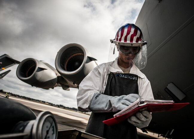 Airman 1st Class Nicholas McCracken, 437th Aircraft Maintenance Squadron crew chief, uses a technical order to complete the 20-step process of transferring liquid oxygen onto a C-17 Globemaster III March 19, 2013, at Joint Base Charleston – Air Base, S.C. Liquid oxygen is used as a means of distributing breathable air to aircrew members and passengers above 10,000 feet above sea level. The C-17 can hold approximately 155 gallons of LOX.  (U.S. Air Force photo/Senior Airman Dennis Sloan)