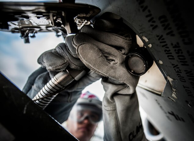 Airman 1st Class Nicholas McCracken, 437th Aircraft Maintenance Squadron crew chief, attaches a metal hose from a liquid oxygen tank to a port on a C-17 Globemaster III March 19, 2013, at Joint Base Charleston – Air Base, S.C. The 20-step process of transferring LOX to the aircraft can take more than an hour. Liquid oxygen is used as a means of distributing breathable air to aircrew members and passengers above 10,000 feet above sea level. The C-17 can hold approximately 155 gallons of LOX.  (U.S. Air Force photo/Senior Airman Dennis Sloan)
