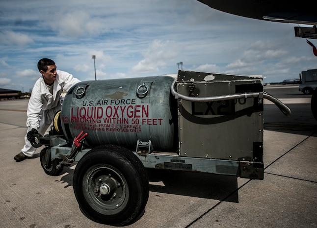 Airman 1st Class Nicholas McCracken, 437th Aircraft Maintenance Squadron crew chief, maneuvers a liquid oxygen tank in front of a C-17 Globemaster III before transferring LOX onto the aircraft March 19, 2013, at Joint Base Charleston – Air Base, S.C. McCracken uses a technical order to complete the 20-step process of transferring LOX onto the aircraft. Liquid oxygen is used as a means of distributing breathable air to aircrew members and passengers above 10,000 feet above sea level. The C-17 can hold approximately 155 gallons of LOX.  (U.S. Air Force photo/Senior Airman Dennis Sloan)