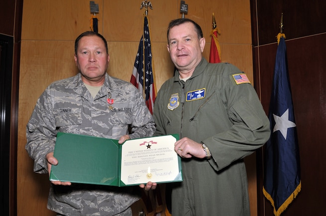 Master Sergeant Vince Tanner, from the 130th Engineering Installation Squadron, posed with Brig. Gen. David Fountain, the Assistant Adjutant General for Air, after receiving the Bronze Star medal. For deployment achievements supporting Operation Enduring Freedom during 2011 and 2012, two Bronze Stars and 28 additional medals were awarded to 18 members of the 130 EIS during a ceremony at the Utah Air National Guard Base Jan. 6. (U.S. Air Force photo by Tech. Sgt. Jeremy Giacoletto-Stegall)(RELEASED)