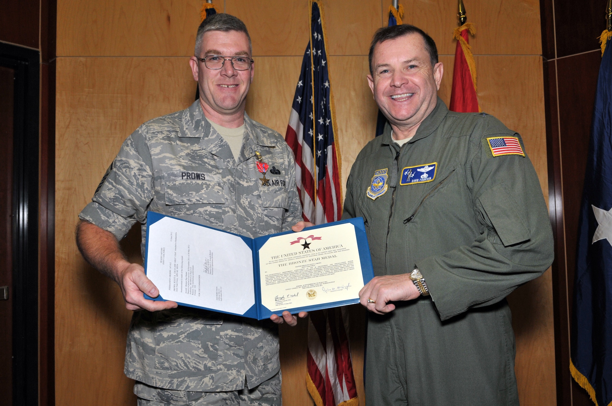 Master Sergeant Scott Prows, from the 130th Engineering Installation Squadron, posed with Brig. Gen. David Fountain, the Assistant Adjutant General for Air, after receiving the Bronze Star medal. For deployment achievements supporting Operation Enduring Freedom during 2011 and 2012, two Bronze Stars and 28 additional medals were awarded to 18 members of the 130 EIS during a ceremony at the Utah Air National Guard Base Jan. 6. (U.S. Air Force photo by Tech. Sgt. Jeremy Giacoletto-Stegall)(RELEASED)