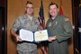 Master Sergeant Scott Prows, from the 130th Engineering Installation Squadron, posed with Brig. Gen. David Fountain, the Assistant Adjutant General for Air, after receiving the Bronze Star medal. For deployment achievements supporting Operation Enduring Freedom during 2011 and 2012, two Bronze Stars and 28 additional medals were awarded to 18 members of the 130 EIS during a ceremony at the Utah Air National Guard Base Jan. 6. (U.S. Air Force photo by Tech. Sgt. Jeremy Giacoletto-Stegall)(RELEASED)