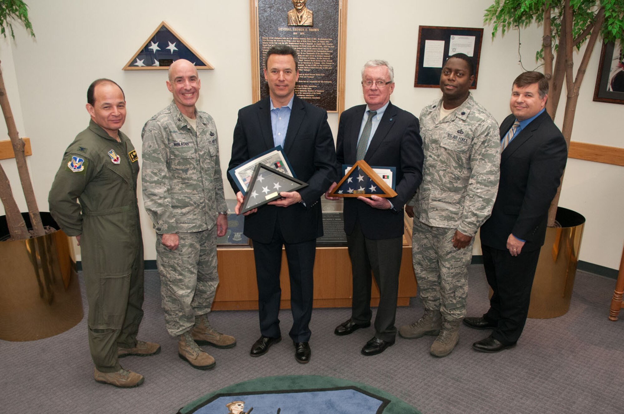 HANSCOM AIR FORCE BASE, Mass. – (left to right) Col. Juan Gaud, 66th Air Base Group deputy commander, Col. Lester A. Weilacher, 66th Air Base Group commander, Jonathan Elias, WBZ-TV anchor, retired Navy Capt. Thomas Kelley, Medal of Honor recipient, Lt. Col. Romero Reid, 66th Air Base Group deputy commander, and Tom Fredericks, 66th Air Base Group deputy director, pose for a photo in the Brown Building March 13. Elias and Kelley were presented with a flag that was flown in Afghanistan by Reid as thanks for their support for the base. (U.S. Air Force photo by Rick Berry)