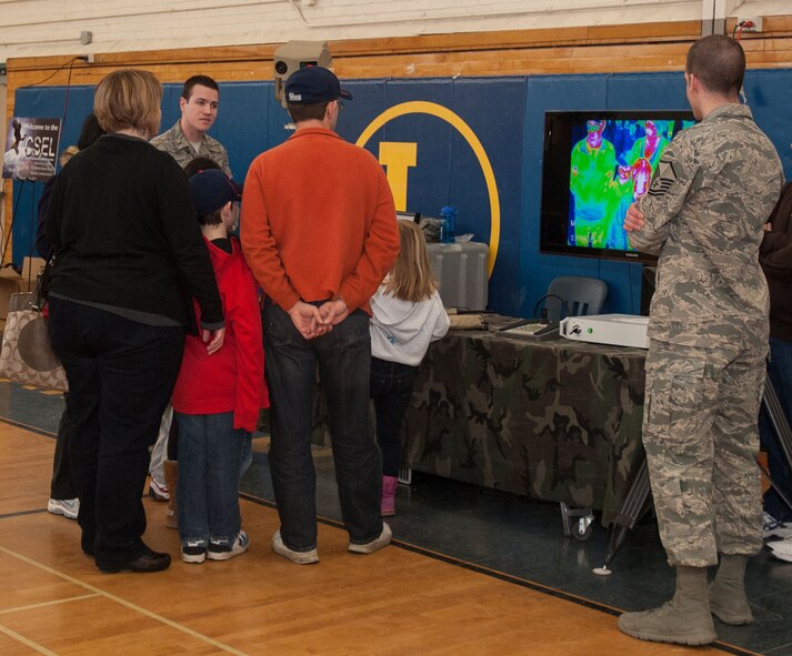 LEXINGTON, Mass. – Second Lt. William Stratemeyer and Master Sgt. Timothy Gatherum (right) demonstrate equipment to visitors at the Lexington 300th anniversary celebration at Lexington High School March 16. The event kicked off the town’s anniversary celebrations and allowed Hanscom to showcase some of the programs that are managed on the base. (U.S. Air Force photo by Mark Herlihy)