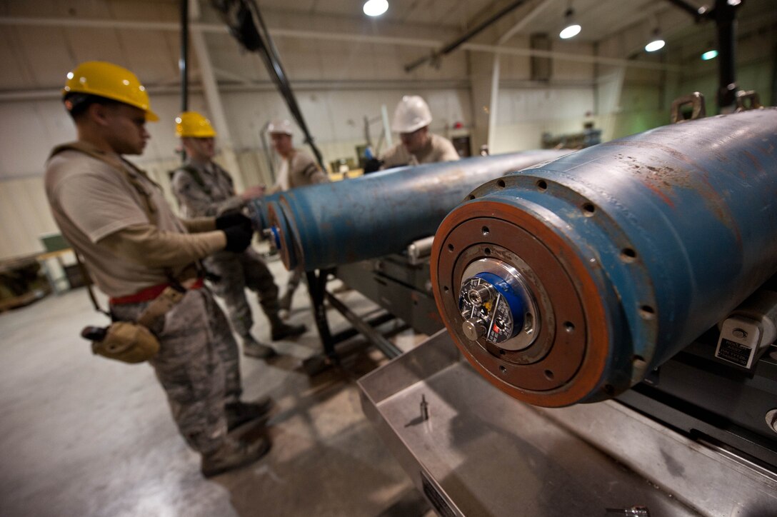Conventional Maintenance crew members assigned to the 28th Munitions Squadron assemble inert guided bomb units during an Operational Readiness Exercise at Ellsworth Air Force Base, S.D., March 19, 2013. The 28th MUNS provide conventional munitions, armament systems and trained munitions personnel. (U.S. Air Force photo by Airman 1st Class Zachary Hada/Released)