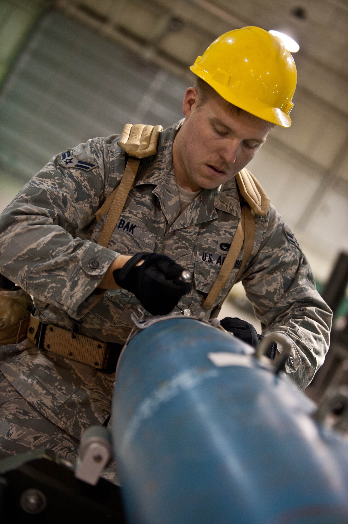 Airman 1st Class Joseph Bak, 28th Munitions Squadron conventional maintenance crew member, assembles an inert guided bomb unit during an Operational Readiness Exercise at Ellsworth Air Force Base, S.D., March 19, 2013. The 28th MUNS Airmen are responsible for 1,707 munitions line items, 86 facilities and a 647–acre munitions storage area to support B-1 bomber operations. (U.S. Air Force photo by Airman 1st Class Zachary Hada/Released)