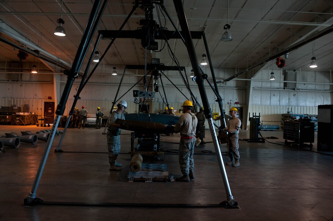 Conventional Maintenance crew members assigned to the 28th Munitions Squadron assemble inert guided bomb units during an Operational Readiness Exercise at Ellsworth Air Force Base, S.D., March 19, 2013. The 28th MUNS’ goal during the ORE was to evaluate the effectiveness, maintainability suitability, and accuracy of precision guided munitions and other advanced air to ground weapons. (U.S. Air Force photo by Airman 1st Class Zachary Hada/Released)