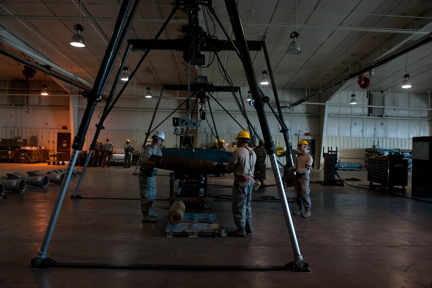 Conventional Maintenance crew members assigned to the 28th Munitions Squadron assemble inert guided bomb units during an Operational Readiness Exercise at Ellsworth Air Force Base, S.D., March 19, 2013. The 28th MUNS’ goal during the ORE was to evaluate the effectiveness, maintainability suitability, and accuracy of precision guided munitions and other advanced air to ground weapons. (U.S. Air Force photo by Airman 1st Class Zachary Hada/Released)