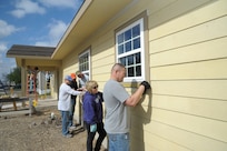 From left: Air Force Master Sgt. Terrence Link, Master Sgt. Jason Hill, Master Sgt. David Wilcox, Chief Master Sgt. Sandy Pfeffer and Master Sgt. Jose Silva, Joint Base San Antonio-Randolph, volunteer at a Habitat for Humanity of San Antonio construction site March 14. For the complete story, see page 4. (U.S. Air Force photo by Joel Martinez)