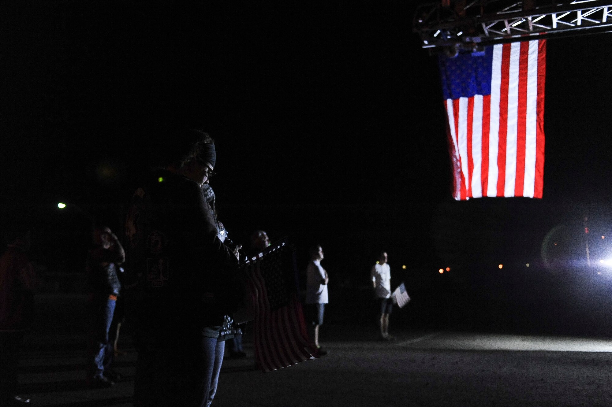 Arkansas Run for the Fallen participants bow their heads during the national anthem March 16, 2013, at Ozark, Ark. This is the second annual Run for the Fallen, an event created to remember the fallen service members of Arkansas. (U.S. Air Force photo by Airman 1st Class Cliffton Dolezal)