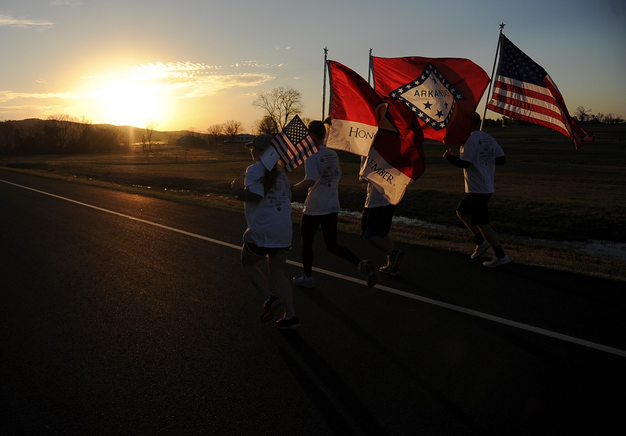 The second team of runners pick up the flags and begins their leg of the event March 16, 2013, at Altus, Ark. Twenty-one four man teams participated in the event by running and carrying the American flag, the Arkansas state flag, the Remember the Fallen flag, as well as, a smaller American flag which had a fallen Arkansan’s bio attached to it. (U.S. Air Force photo by Airman 1st Class Cliffton Dolezal)