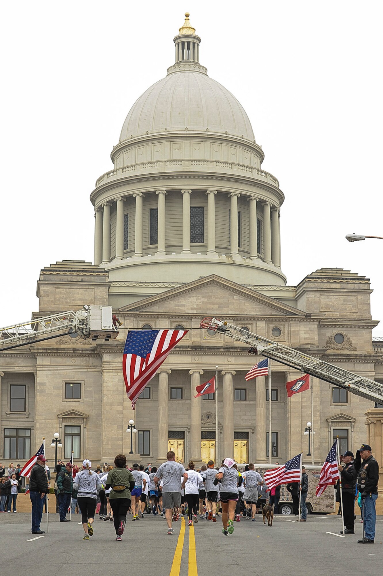 The Arkansas Run for the Fallen comes to a close as the runners marched up the steps of the state Capitol March 17, 2013, at Little Rock, Ark. The last few blocks were lined with American flags being held by Rolling Thunder members. (U.S. Air Force photo by Airman 1st Class Cliffton Dolezal)  