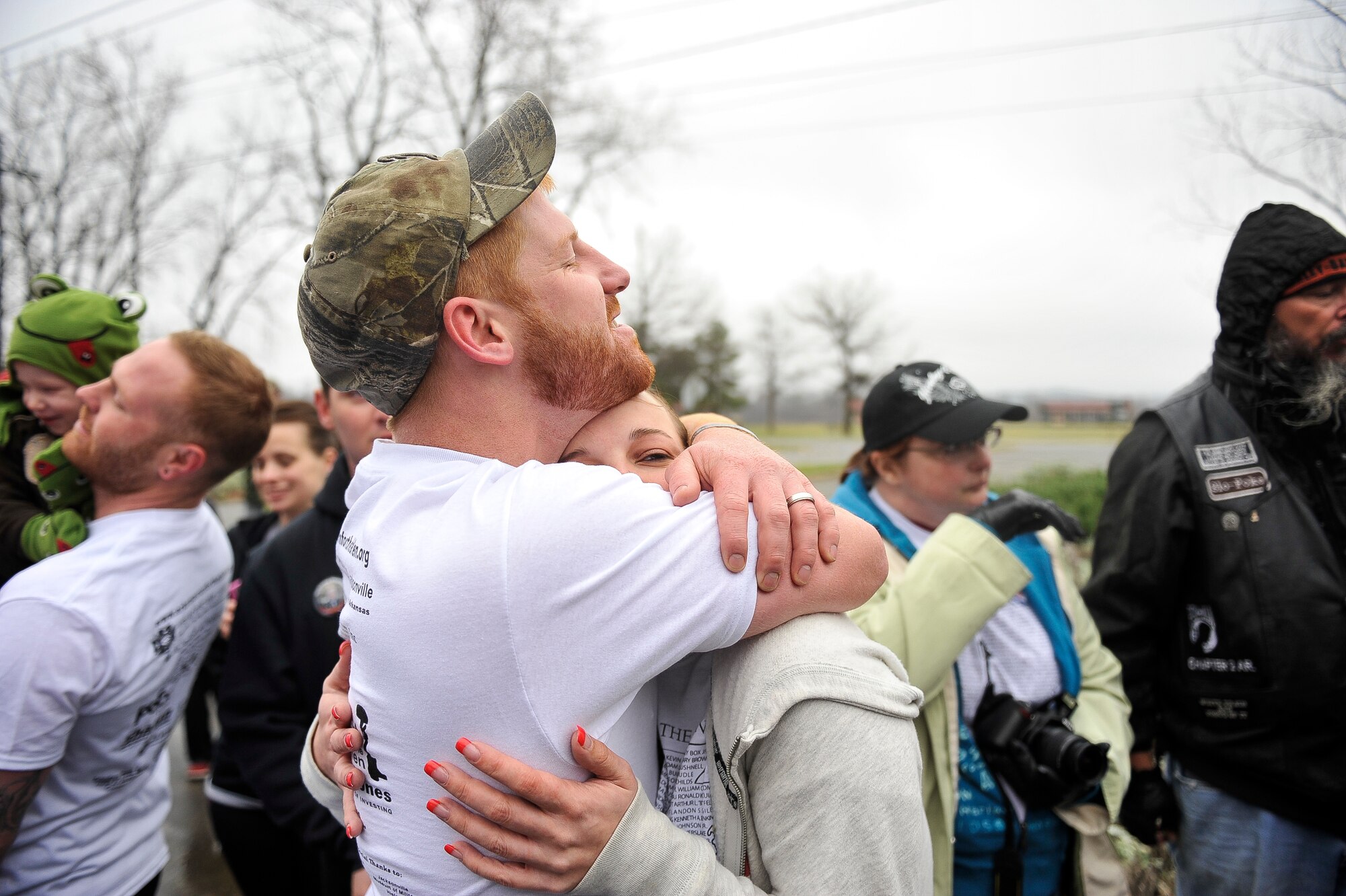 Sam Swindle, brother of fallen Arkansan Jason Swindle, comforts Chelsey Swindle, wife of the fallen service member, as Jason’s flag is put in the ground March 17, 2013, at Little Rock, Ark. The Swindle family finished the remainder of the event by walking to the state Capitol. (U.S. Air Force photo by Airman 1st Class Cliffton Dolezal)