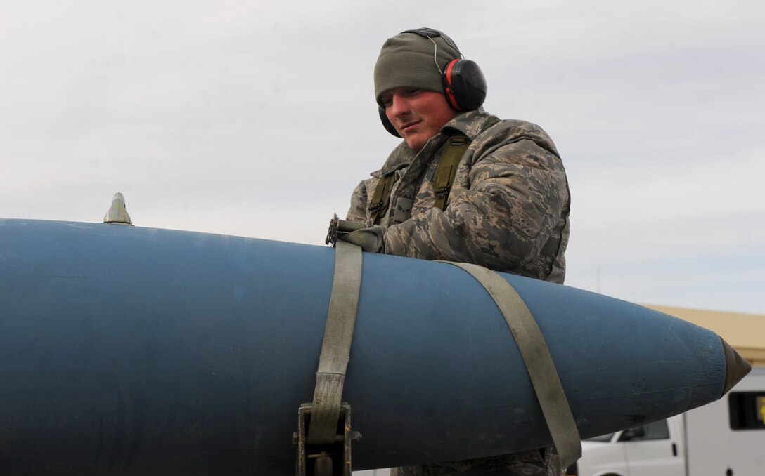 Airman 1st Class Caleb Burker, 28th Aircraft Maintenance Squadron weapons load crew member, secures an MK-82 training munition onto a trailer during an Operational Readiness Exercise at Ellsworth Air Force Base, S.D., March 20, 2013. Munitions must be properly secured to prevent mishaps and injuries. (U.S. Air Force photo by Airman 1st Class Anania Tekurio/Released)