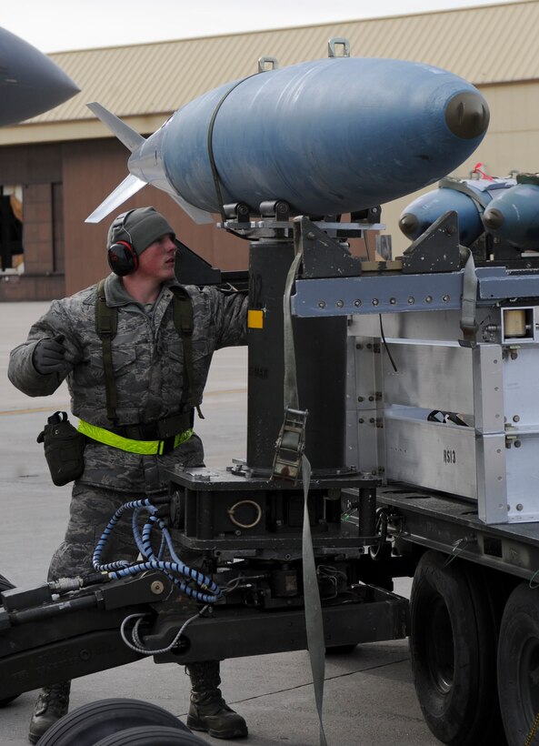 Airman 1st Class Caleb Burker, 28th Aircraft Maintenance Squadron weapons load crew member, guides a Mk-82 training munition onto a trailer during an Operational Readiness Exercise at Ellsworth Air Force Base, S.D., March 20, 2013. The ORE covered a wide range of operations, testing Airmen’s ability to deploy aircraft and equipment to different regions around the world. (U.S. Air Force photo by Airman 1st Class Anania Tekurio/Released)