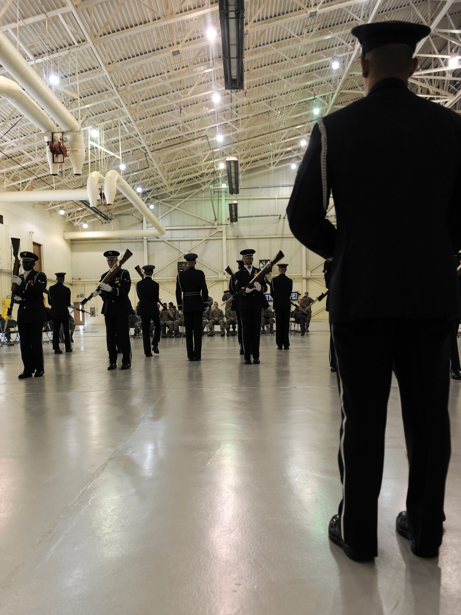A U.S. Air Force Honor Guard Drill Team member watches as his team performs different drill movements at Moody Air Force Base, Ga., March 14, 2013. The drill team is just one of the many different groups that make up the Air Force Honor Guard. (U.S. Air Force photo by Airman Alexis Grotz/Released)