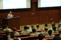 First Lt. Timothy Ramig, 28th Force Support Squadron food service officer, welcomes attendees during an “Introduction to Commissioning” class at the Deployment Center at Ellsworth Air Force Base, S.D., March 15, 2013. During the event, officers from a number of backgrounds explained how they earned their commissions, answered questions and helped Airmen prepare their packages for Officer Training School. (U.S. Air Force photo by Airman 1st Class Hrair H. Palyan/Released)