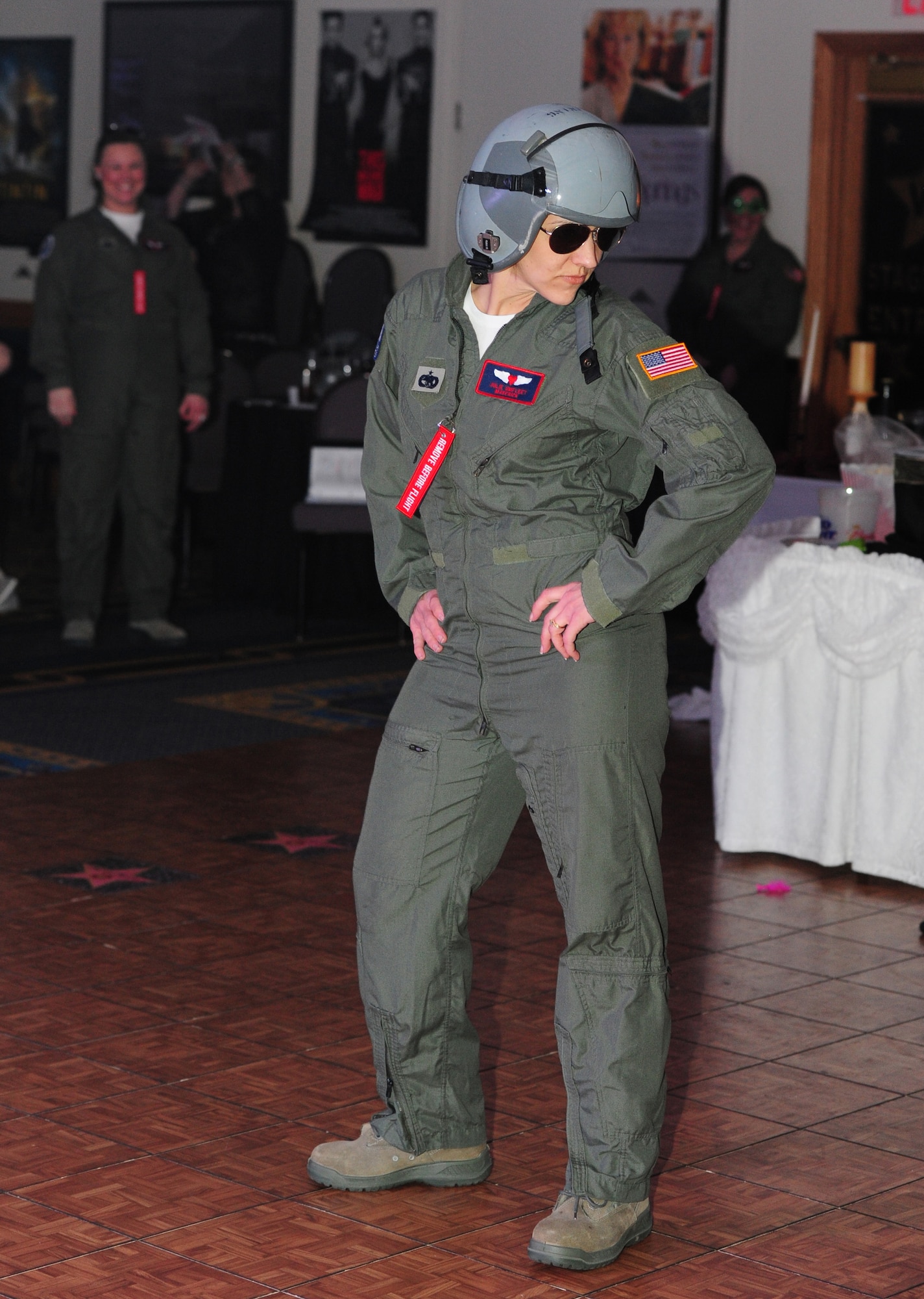 Julie Umfleet, 509th Logistics Readiness Squadron key spouse and wife of Senior Master Sgt. Mark Umfleet, performs the “Harlem Shake” during Whiteman Air Force Base’s first annual Spouses’ Dining-In at Mission’s End March 16, 2013. The event was funded with donations given to each of the 509th Bomb Wing’s key spouse organizations and included food, games, skits and a dance hosted by a live disc-jockey. (U.S. Air Force photo by Staff Sgt. Nick Wilson/Released)