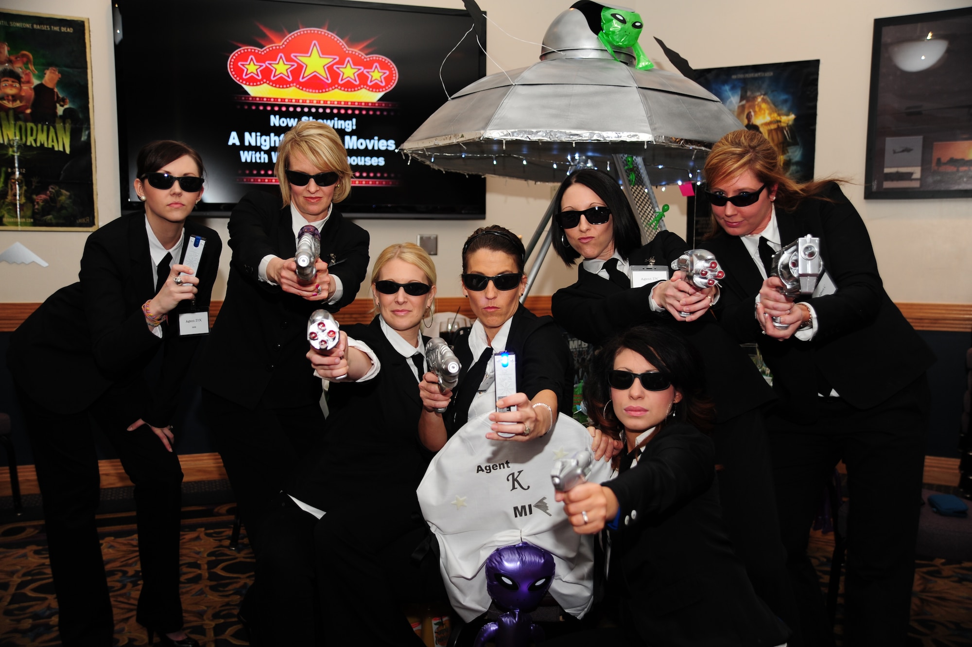 Spouses of members from the 393rd Bomb Squadron dress as Men in Black during Whiteman Air Force Base’s first annual Spouses’ Dining-In at Mission’s End March 16, 2013. The event was put together to strengthen morale and team-building among the spouses in the 509th Bomb Wing. (U.S. Air Force photo by Staff Sgt. Nick Wilson/Released)
