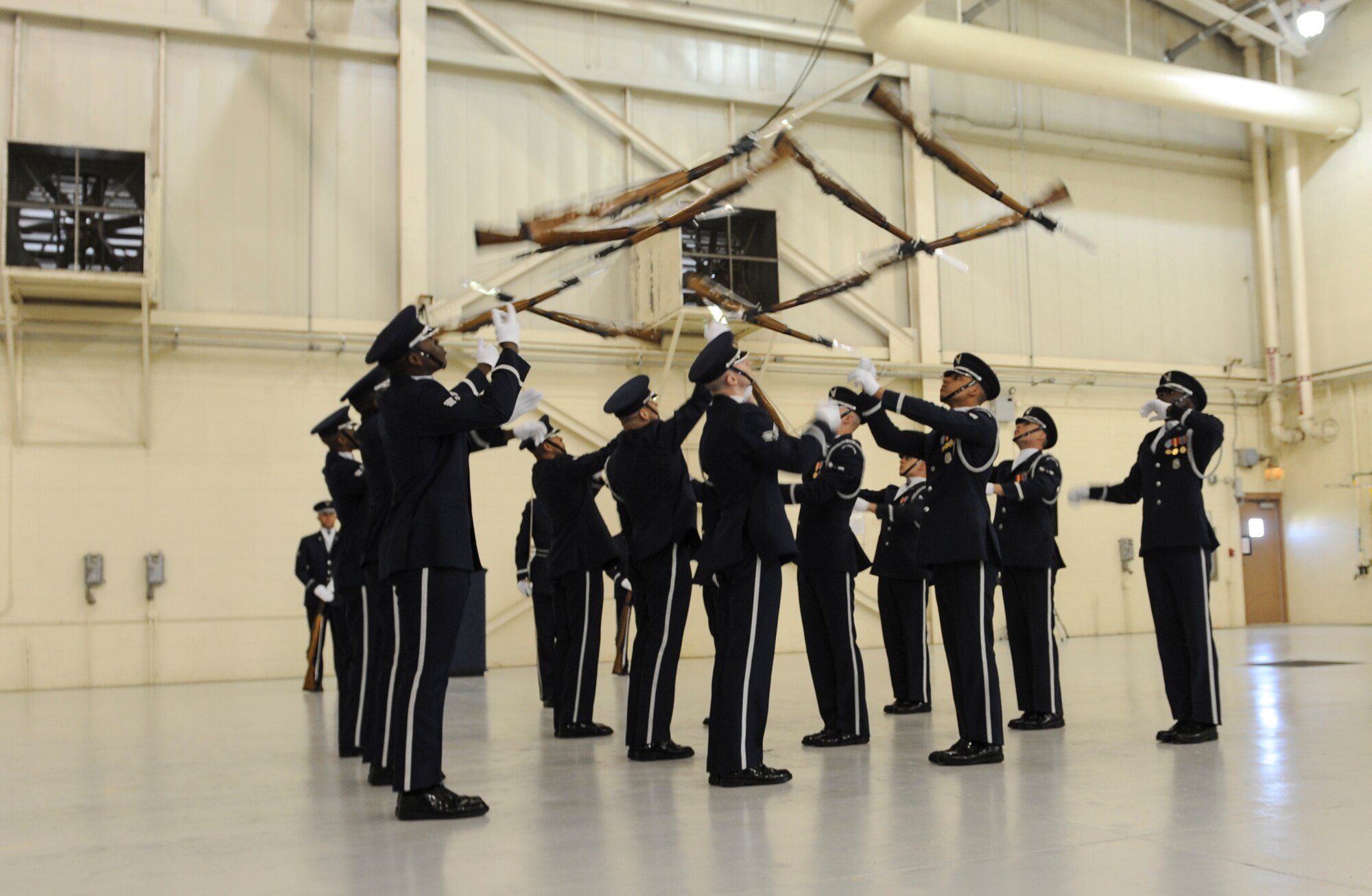 U.S. Air Force Honor Guard Drill Team members throw their M-1 rifles during a performance at Moody Air Force Base, Ga., March 14, 2013. The drill team executes their movements with precision while using the 10-pound rifle.  (U.S. Air Force photo by Airman Alexis Grotz/Released)