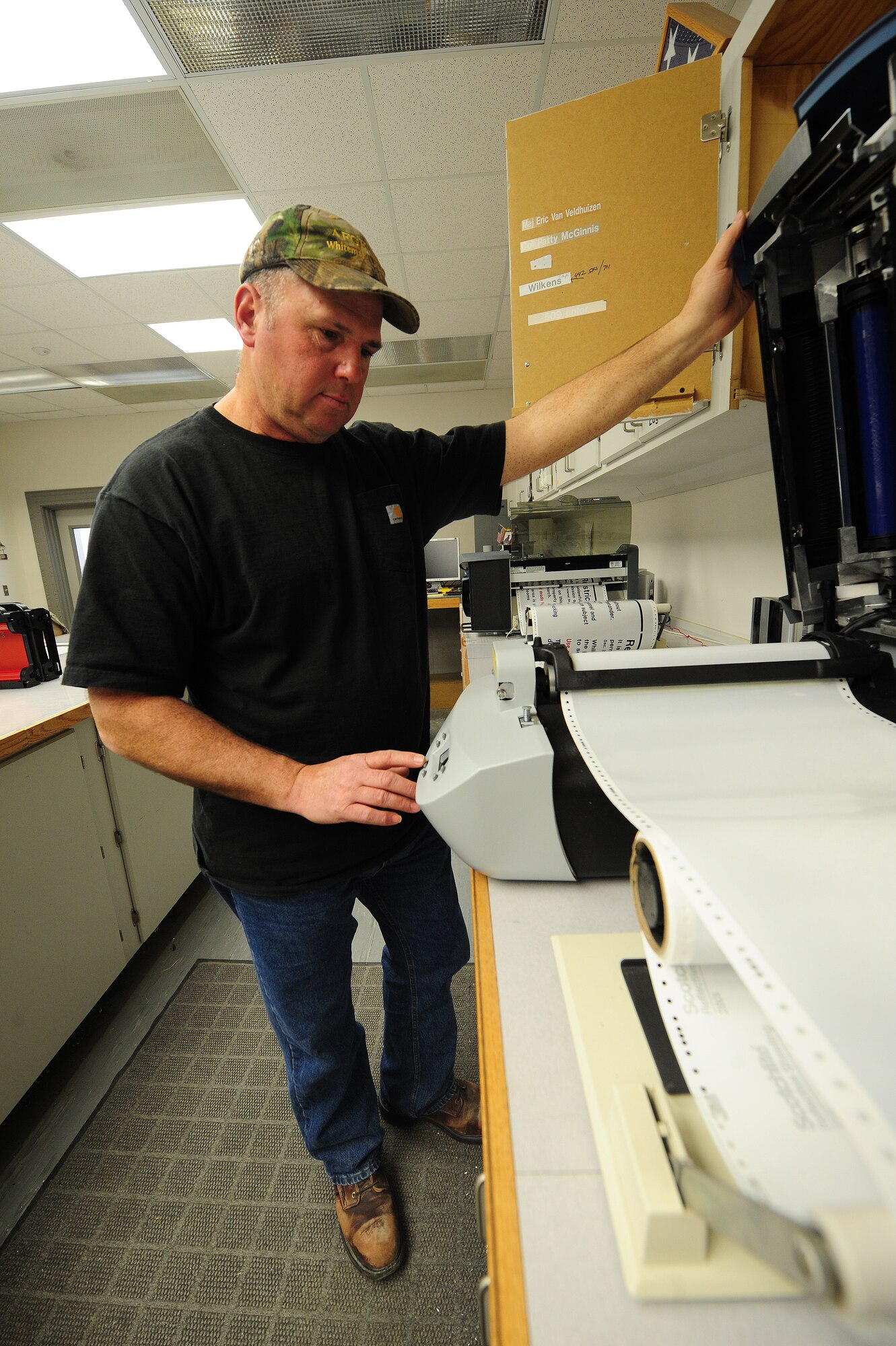 Bernard Jones, 509th Civil Engineer Squadron sign maker, uses a thermal printer to print restricted area signs for a customer at Whiteman Air Force Base, Mo., March 11, 2013. New signs are continually needed for a variety of reasons, including replacement due to weather or updated information.  (U.S. Air Force photo by Staff Sgt. Nick Wilson/Released)