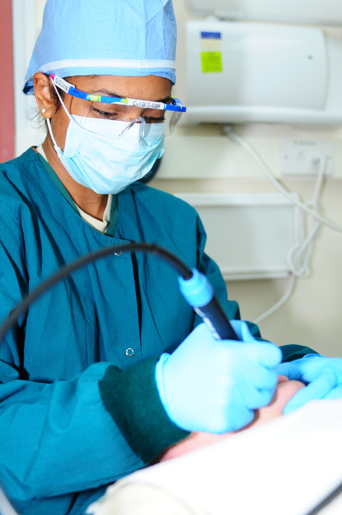 ROYAL AIR FORCE LAKENHEATH, England -- Senior Airman Anna Gibson, 48th Dental Squadron dental technician, preps a patient for oral surgery Feb. 5, 2013. Gibson was nominated for a Liberty Spotlight because she displays the core value of "Excellence in all We Do." (U.S. Air Force photo by Airman 1st Class Dana J. Butler)