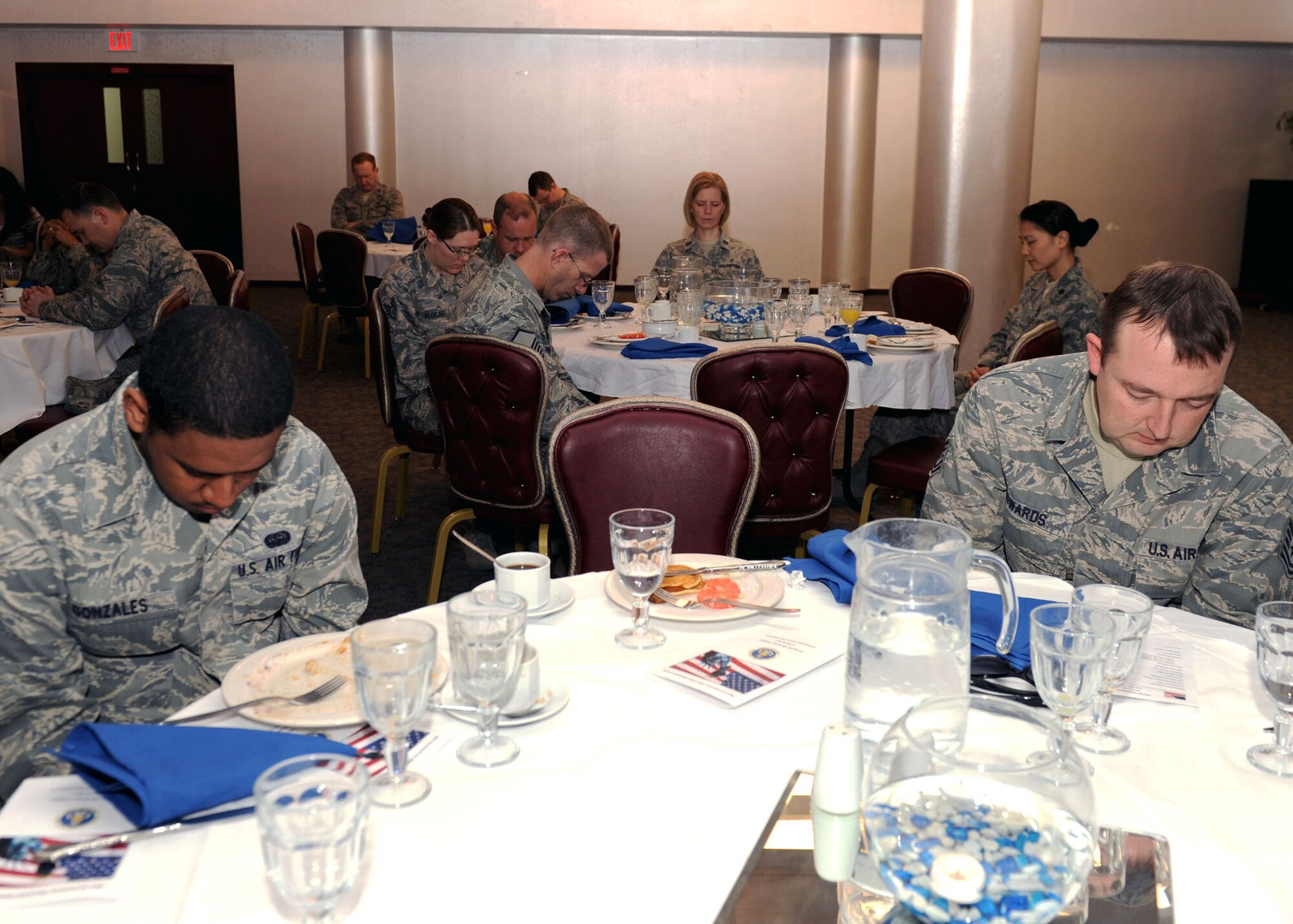 Members of Incirlik bow their heads in prayer during the Commander’s National Prayer Breakfast March 21, 2013, at Incirlik Air Base, Turkey. The event was hosted by the Incirlik chapel staff and included three presentations, followed by prayers from Incirlik Airmen about family, military members and the nation, respectively. (U.S. Air Force photo by Staff Sgt. Marissa Tucker/Released) 