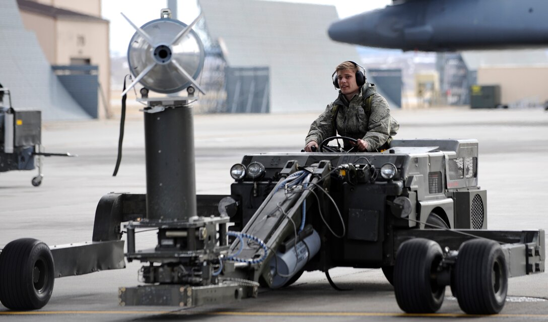 Senior Airman Stefen Ivanovic, 28th Aircraft Maintenance Squadron weapons load crew member, drives a jammer with a Mark-82 training bomb to a waiting munitions trailer on the flightline during an operational readiness exercise at Ellsworth Air Force Base, S.D., March 20, 2013. The ORE, conducted March 19 and 20, tested the ability of Ellsworth Airmen to respond to a deployment tasking and put B-1 bombers in the air. (U.S. Air Force photo by Airman 1st Class Ashley J. Thum/Released)