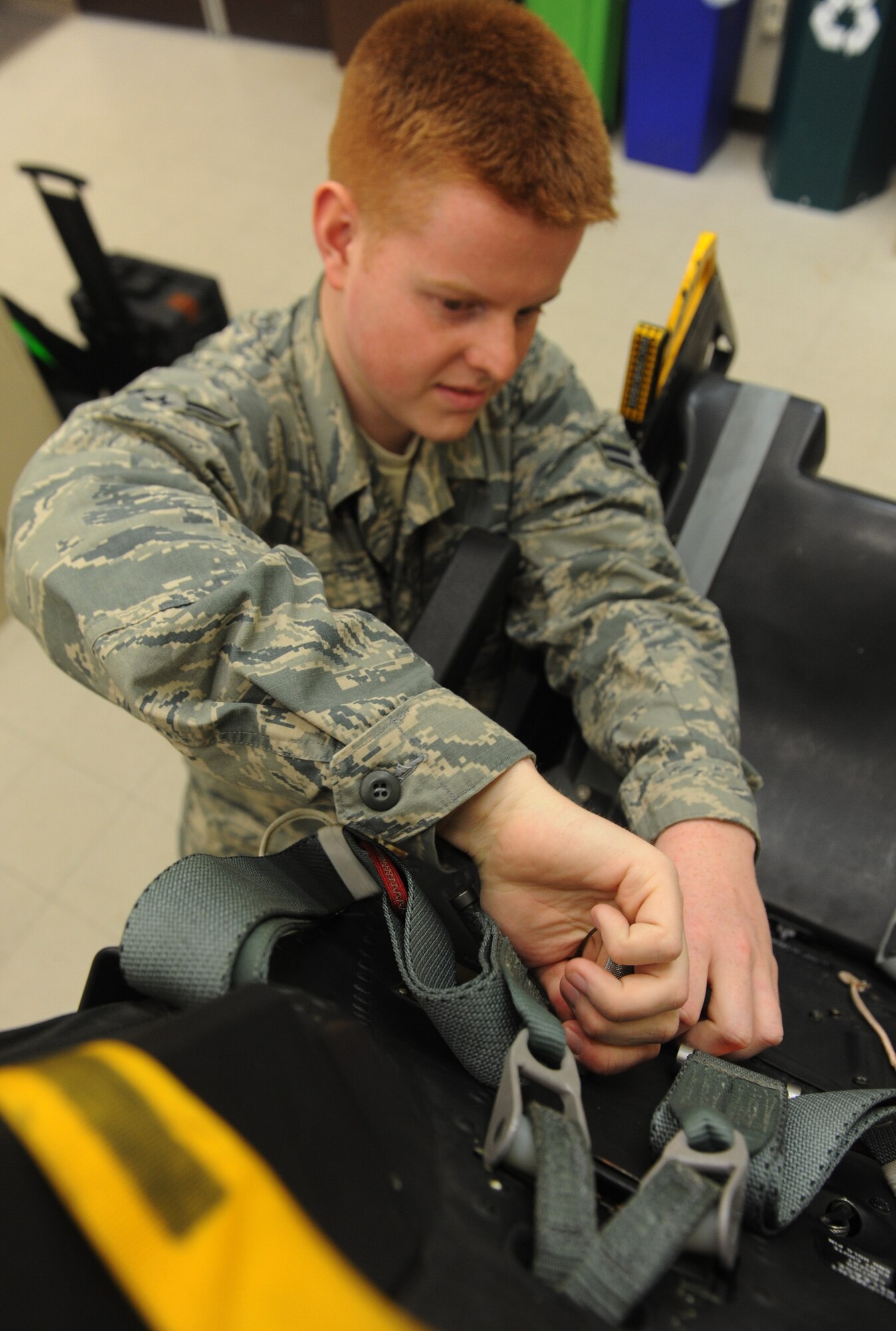 Airman 1st Class Christopher Amsel, 509th Maintenance Squadron egress systems journeyman, places a pin in a training ejection seat at Whiteman Air Force Base, Mo., March 19, 2013. The egress shop has been fully integrated with members of the 131st AMXS egress shop since 2009. (U.S. Air Force photo by Airman 1st Class Bryan Crane/Released)