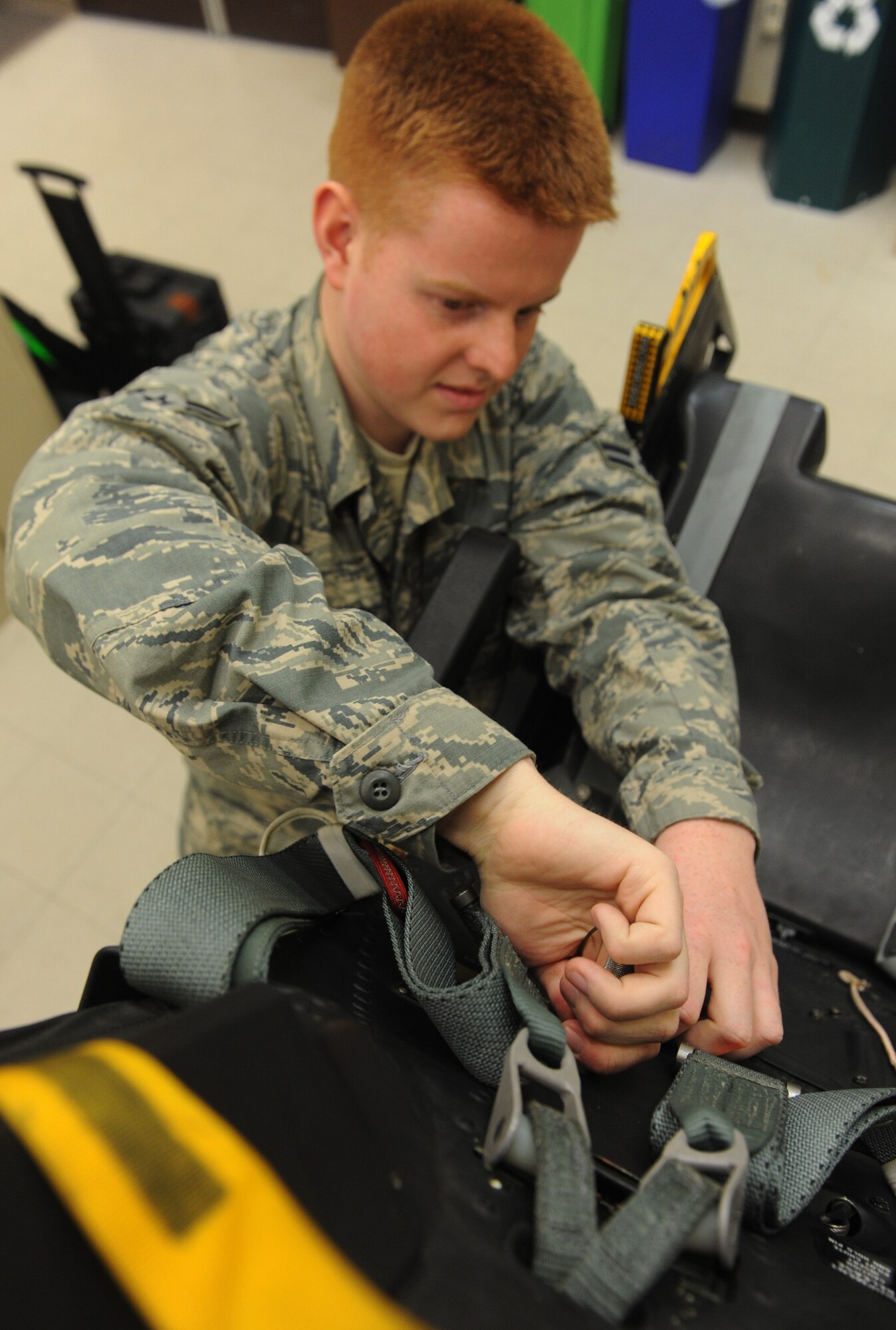 Airman 1st Class Christopher Amsel, 509th Maintenance Squadron egress systems journeyman, places a pin in a training ejection seat at Whiteman Air Force Base, Mo., March 19, 2013. The egress shop has been fully integrated with members of the 131st AMXS egress shop since 2009. (U.S. Air Force photo by Airman 1st Class Bryan Crane/Released)