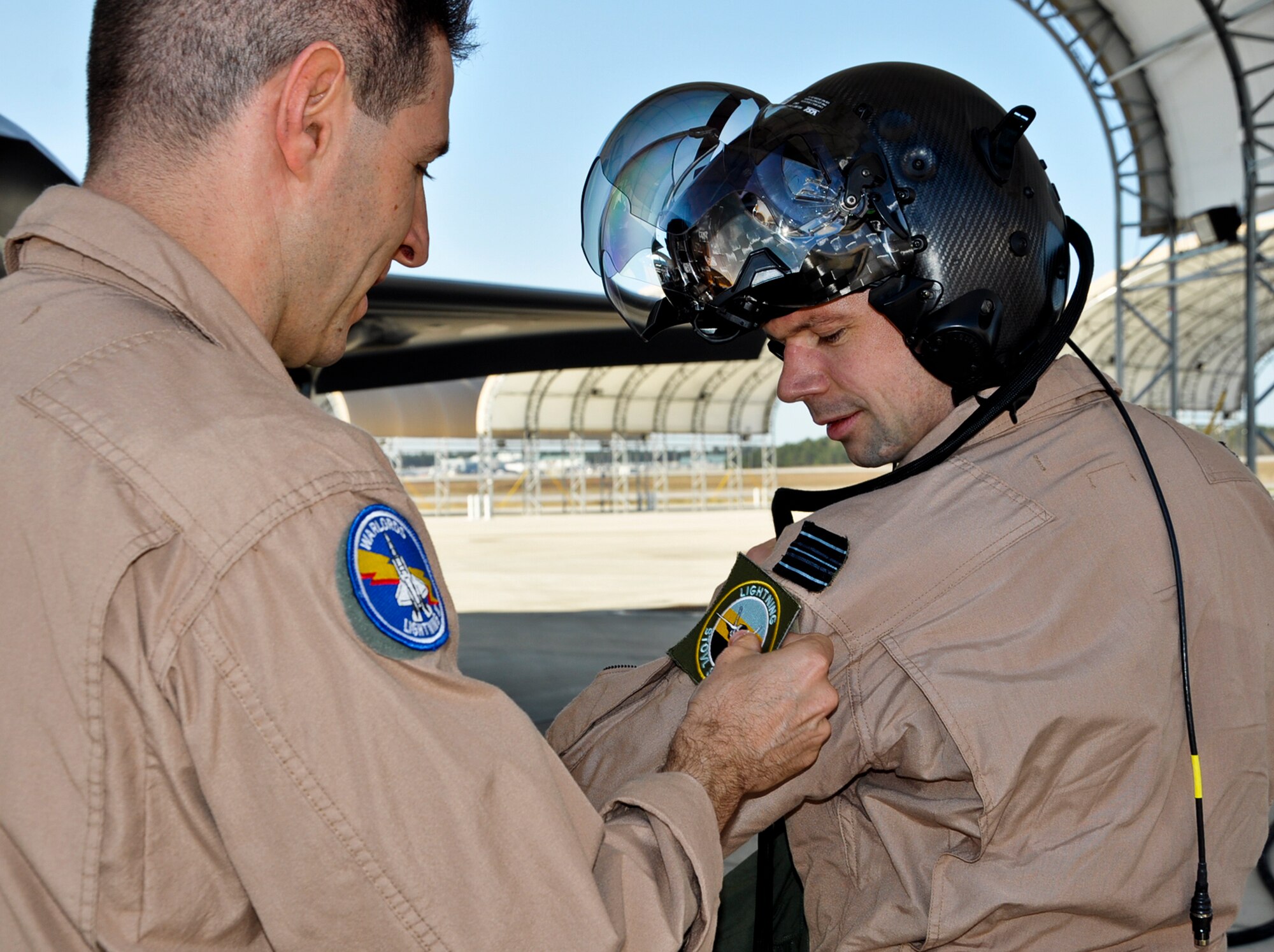 United Kingdom Royal Air Force Squadron Leader Frankie Buchler became the first international student-pilot to fly a sortie in the F-35B Lightning II March 19 at Eglin Air Force Base, Fla.  He received his F-35B Short Take Off/Vertical Landing (STOVL)
 patch after completing the flight.  (U.S. Air Force photo/Maj. Karen Roganov)