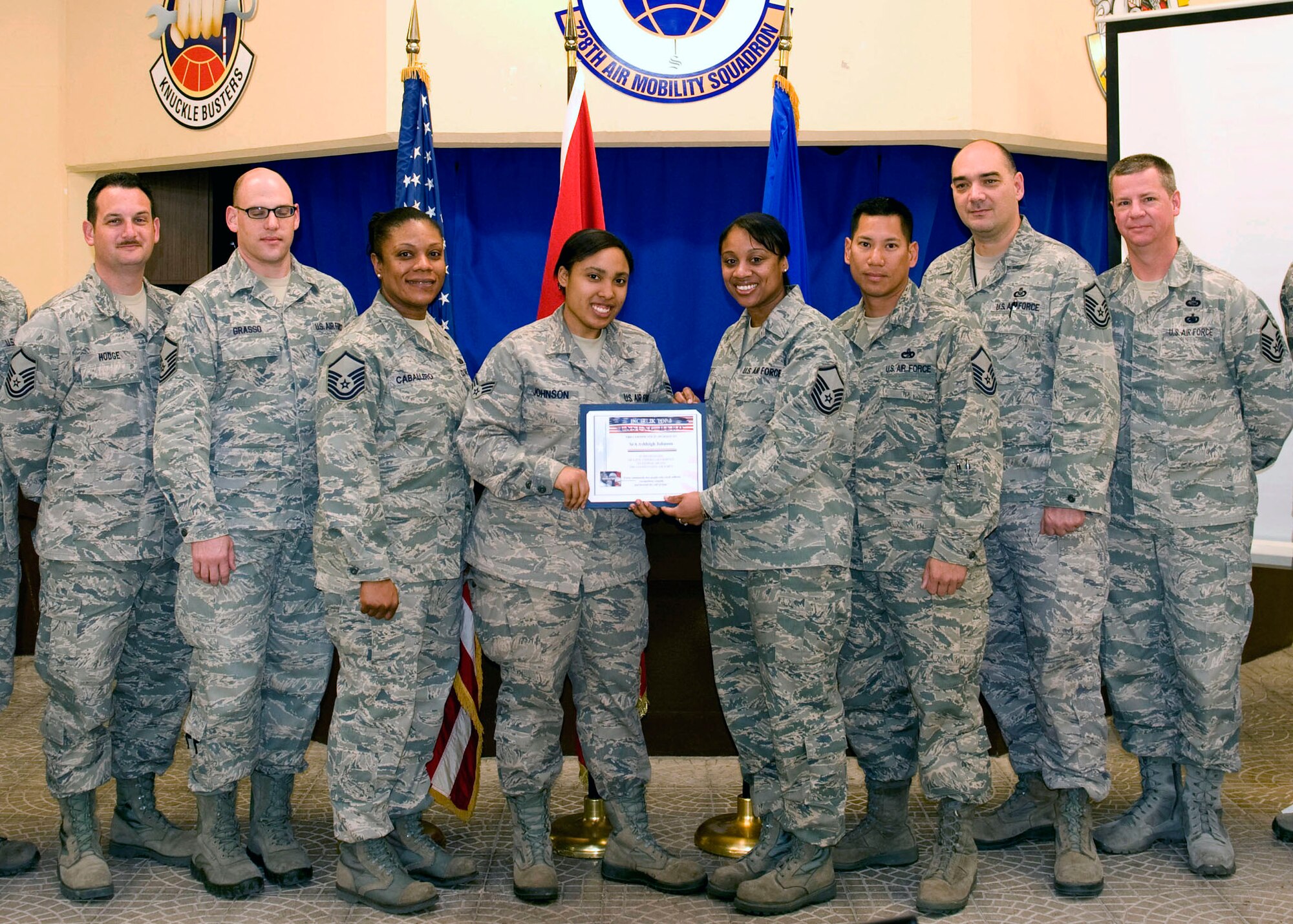 Senior Airman Ashleigh Johnson, 728th Air Mobility Squadron client support technician, receives the Unsung Hero award from the Incirlik Top 3 March 23, 2013, at Incirlik Air Base, Turkey. The organization awarded Johnson with the honor for her efforts in solely repairing a squadron-wide network issue during her off-duty time. The Top 3 presents this award monthly to Airmen who demonstrate superior job performance and exceptional leadership. (U.S. Air Force photo by Staff Sgt. Marissa Tucker)  

