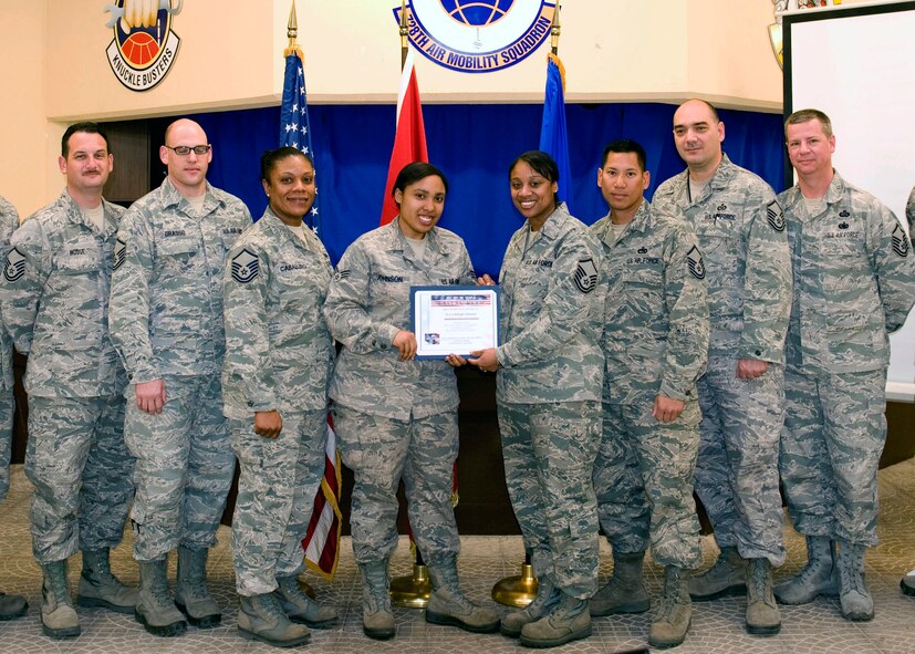 Senior Airman Ashleigh Johnson, 728th Air Mobility Squadron client support technician, receives the Unsung Hero award from the Incirlik Top 3 March 23, 2013, at Incirlik Air Base, Turkey. The organization awarded Johnson with the honor for her efforts in solely repairing a squadron-wide network issue during her off-duty time. The Top 3 presents this award monthly to Airmen who demonstrate superior job performance and exceptional leadership. (U.S. Air Force photo by Staff Sgt. Marissa Tucker)  
