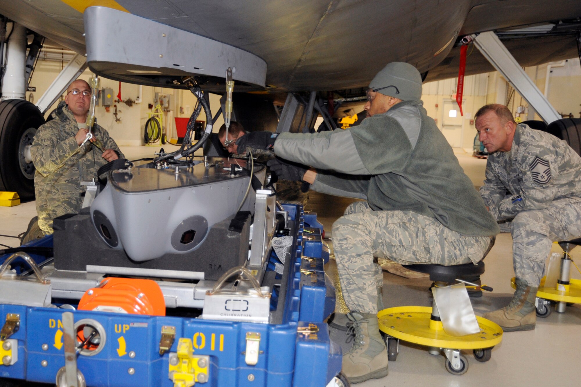 130312-Z-HC784-060 - Technical Sgt. Anthony LaGore helps Technical Sgt. Louis Jones attach the lift cables of a mounting bracket containing a prototype LAIRCM -- large aircraft infrared countermeasure -- pod to a KC-135 Stratotanker as Chief Master Sgt. Henry Ryan looks on at Selfridge Air National Guard Base, Mich., March 12, 2013. All three Airmen are members of the 191st Maintenance Squadron at Selfridge. (Air National Guard photo by John S. Swanson)