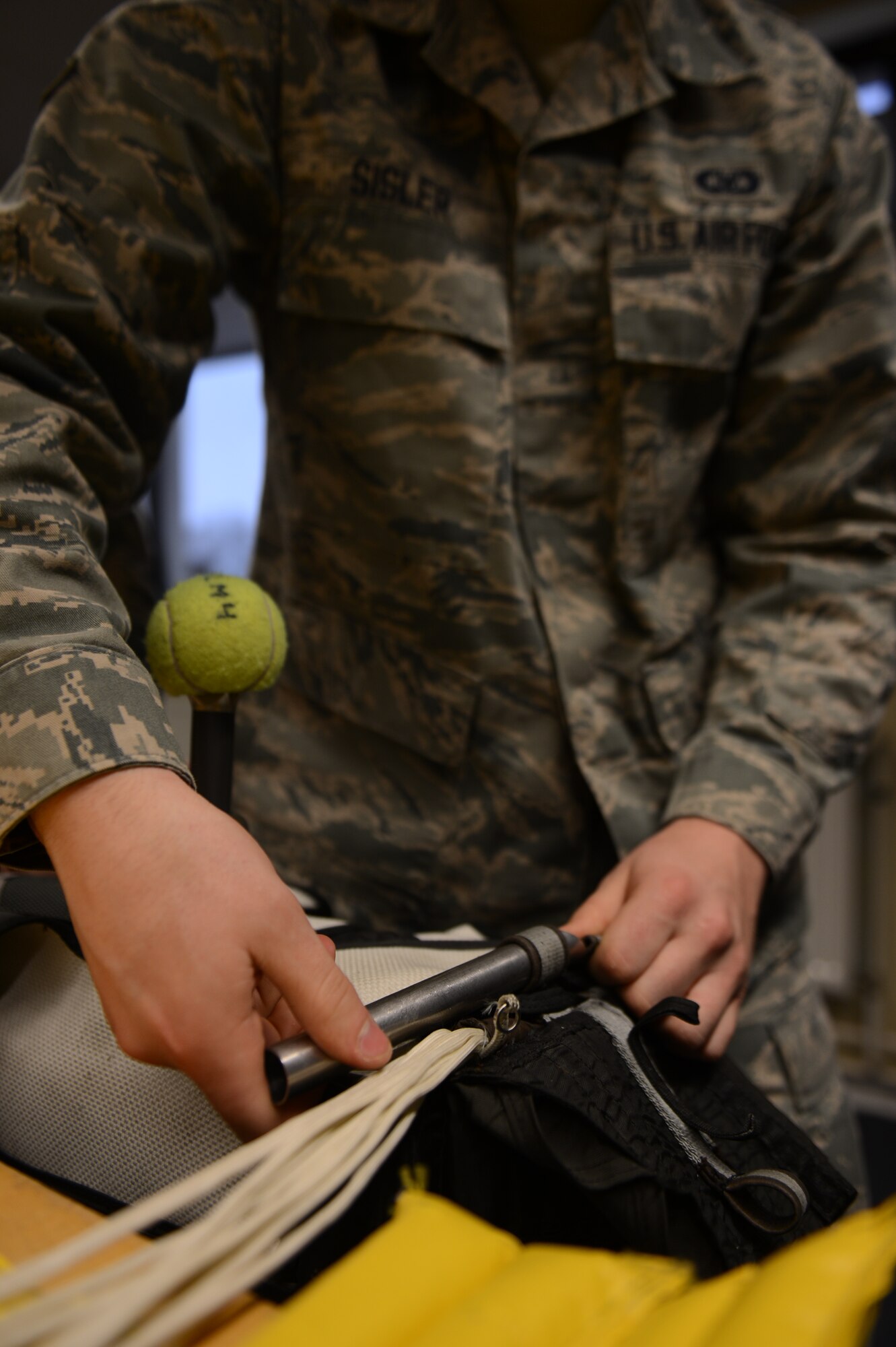 SPANGDAHLEM AIR BASE, Germany – Airman 1st Class Daniel Sisler, 52nd OSS aircrew flight equipment technician from Somerset, Wis., threads parachute cord through an advanced concept ejection seat March 20, 2013. The cord is packed in a specific manner to avoid damage during the explosive ejection during an emergency. (U.S. Air Force photo by Airman 1st Class Gustavo Castillo/Released)