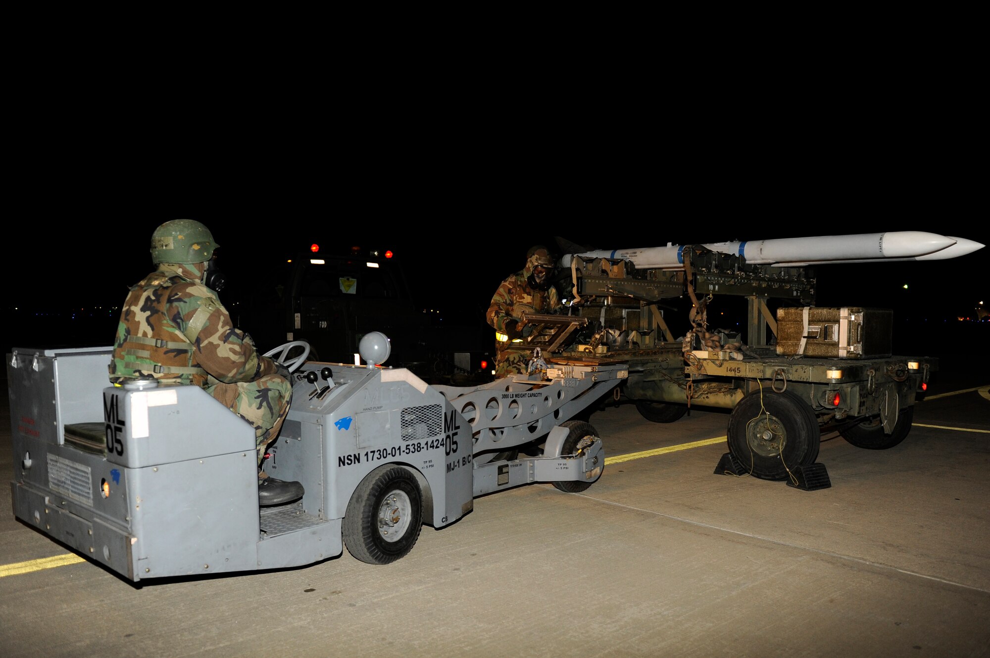 KUNSAN AIR BASE, Republic of Korea -- Staff Sgt. Joshua Chapman, 8th Maintenance Operations Squadron, secures a missile onto a bomb-lift truck during exercise Beverly Midnight 13-2 at Kunsan Air Base, Republic of Korea, March 21, 2013. The exercise helped maintenance members demonstrate their ability to respond to various scenarios. (U.S. Air Force photo by Senior Airman Marcus Morris/Released)