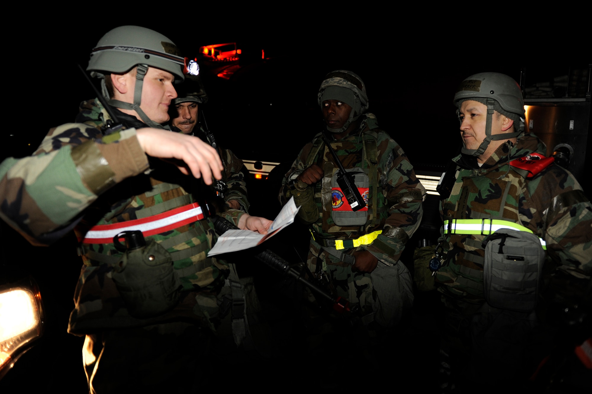 KUNSAN AIR BASE, Republic of Korea -- Staff Sgt. Clayton Cook, 8th Civil Engineer Squadron disaster assistance response team member, left, talks to exercise evaluation team members about procedures 8th CES would take when responding to a fuel station hit by a simulated mortar during exercise Beverly Midnight 13-2 at Kunsan Air Base, Republic of Korea, March 21, 2013. The scenario demonstrated the Wolf Pack’s ability to react to fire as a result of a mortar attack.  (U.S. Air Force photo by Senior Airman Marcus Morris/Released)